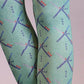 TABBISOCKS brand PDX Carpet Patterned Tights, enlarged view of the knee area of a woman's leg wearing tights that are emerald green in color with an overall PDX Carpet pattern