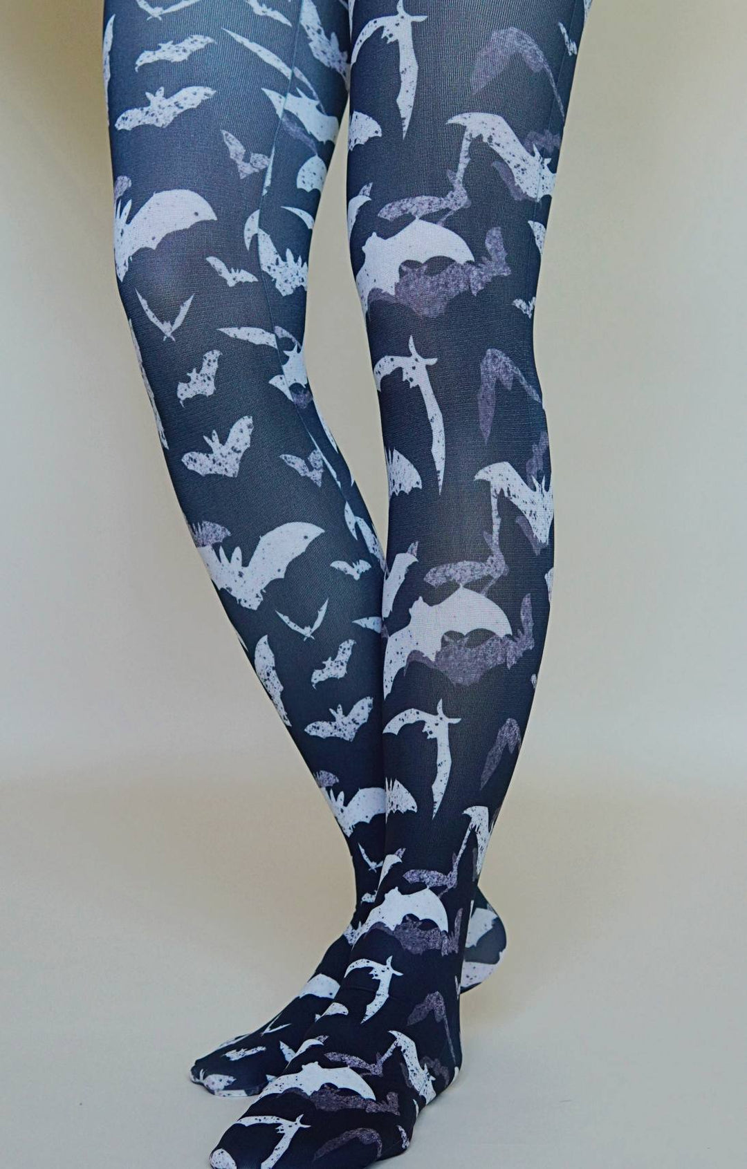 Black leggings with white bats pattern on a tights.