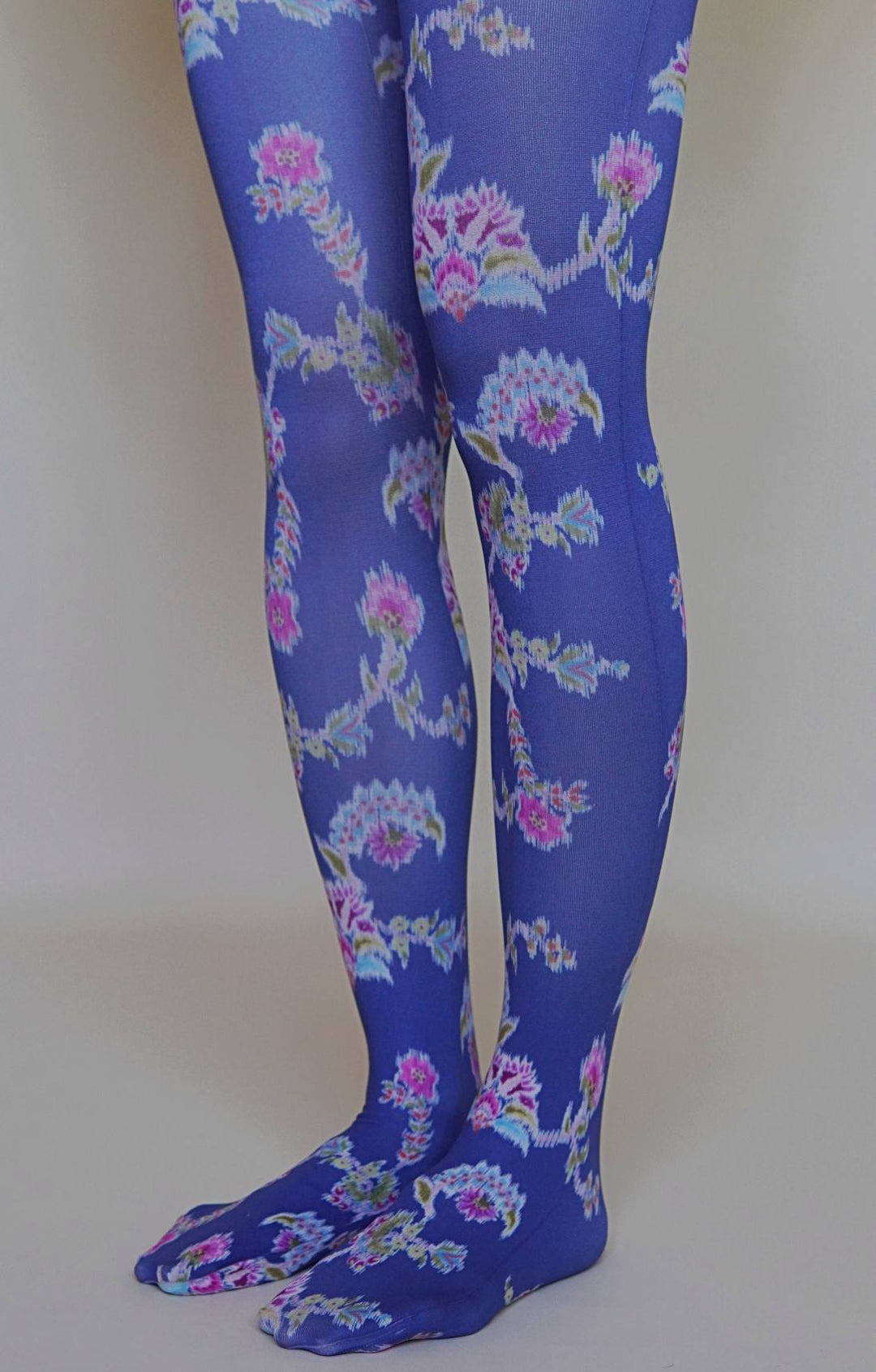 Blue floral patterned tights on a plain background