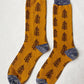 TABBISOCKS brand Replant Pairs Tree Socks in Mustard color with a Grey color at the cuff and toe and a brown tree design throughout the sock.
