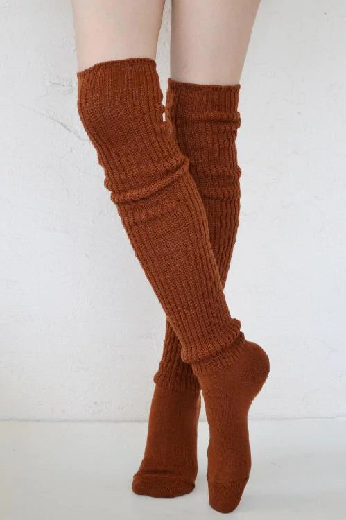 Female leg wearing TABBISOCKS brand Scrunchy Over the Knee Socks, a knee-length knee sock in the brownish Amber color