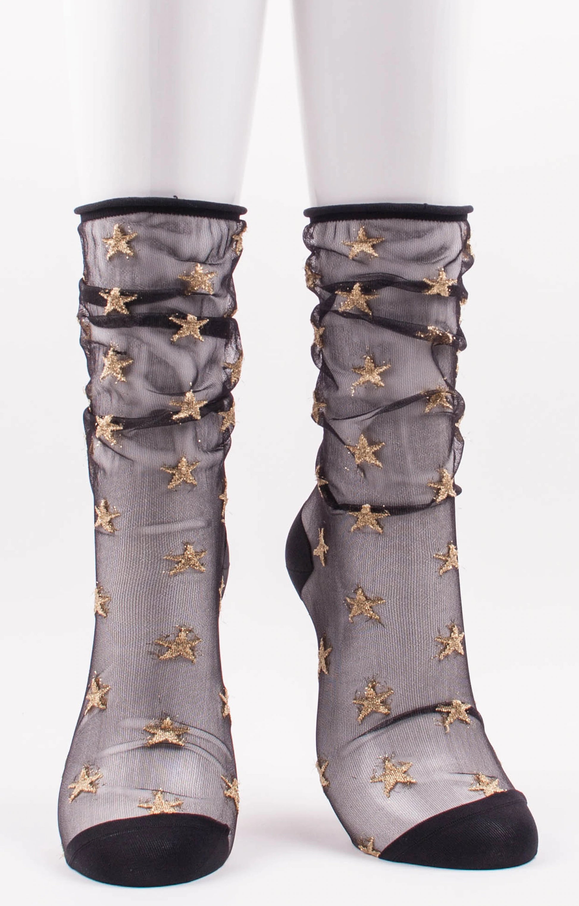 TABBISOCKS brand Sheer Star Tulle Socks in BLACK GOLD color with gold star embroidery scattered on transparent black fabric design