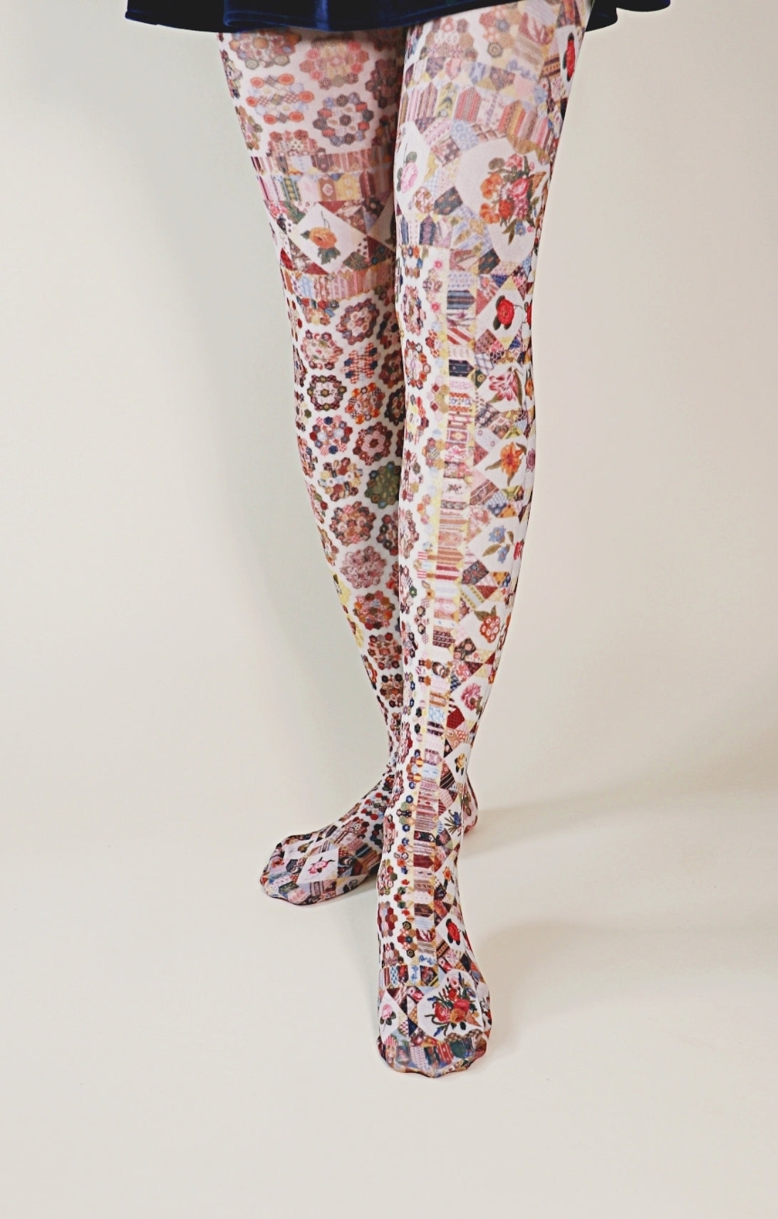 Overall reddish fabric with geometric patterns throughout the tights