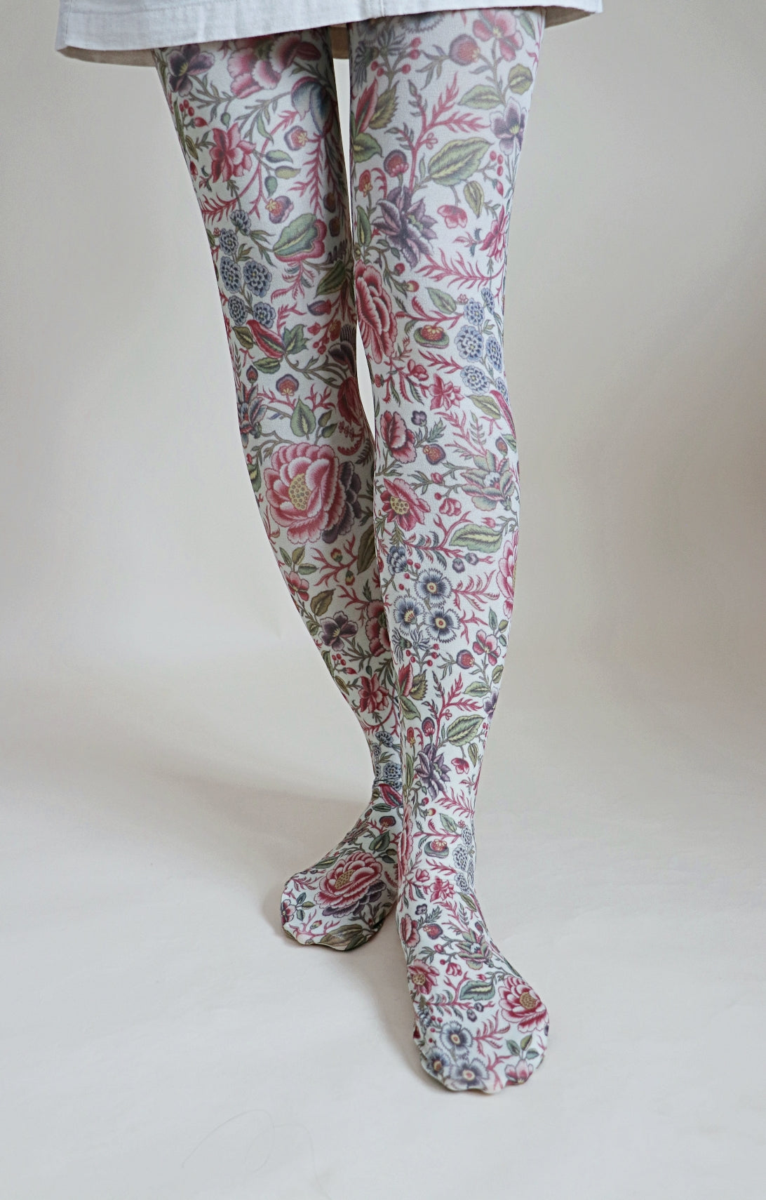 Overall whitish fabric with red floral pattern throughout the tights