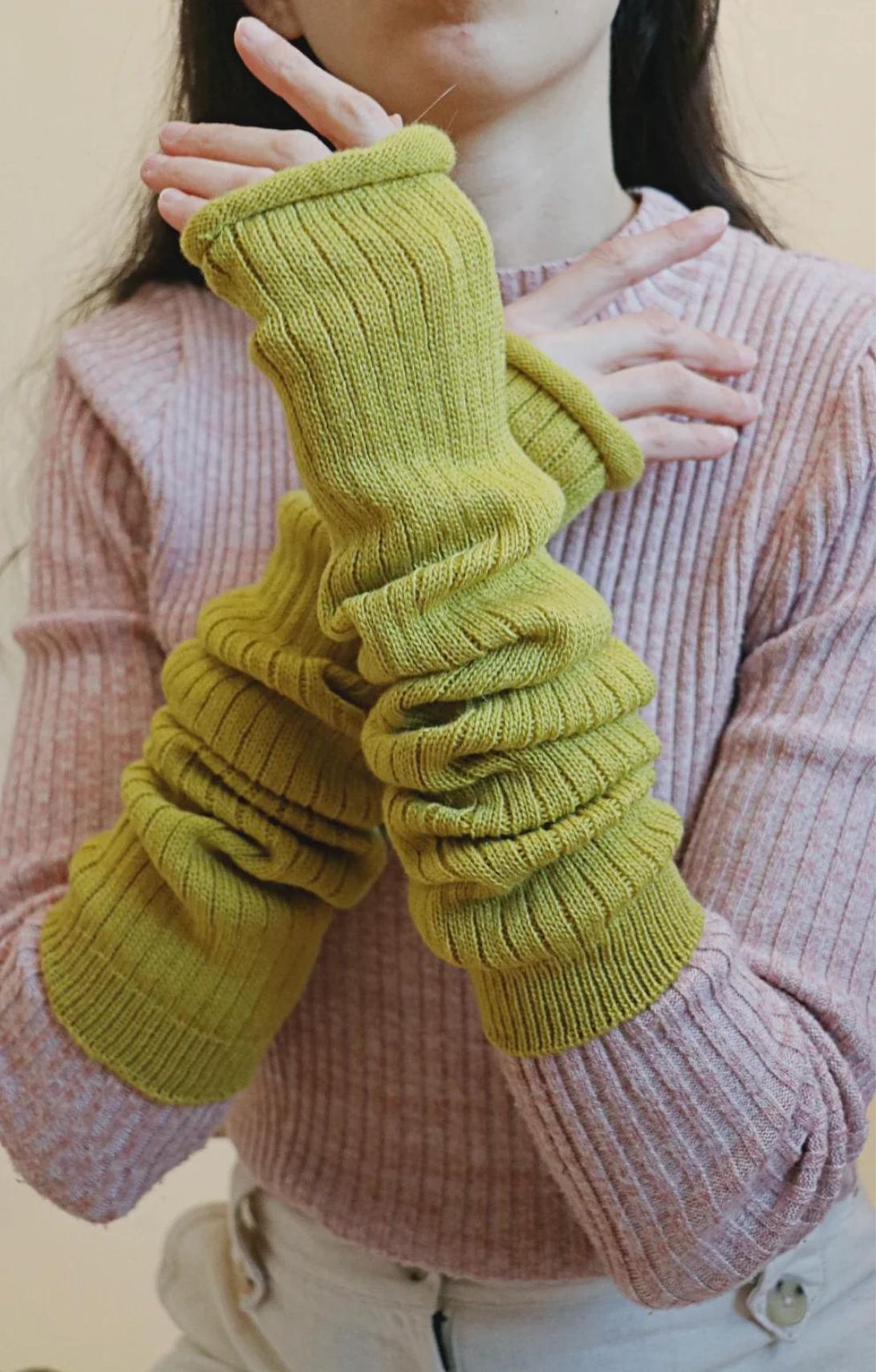 Arm of a woman wearing an ivory-colored sweater wearing the Bitter Yellow color of TABBISOCKS brand Wool Blend Leg and Arm Warmers
