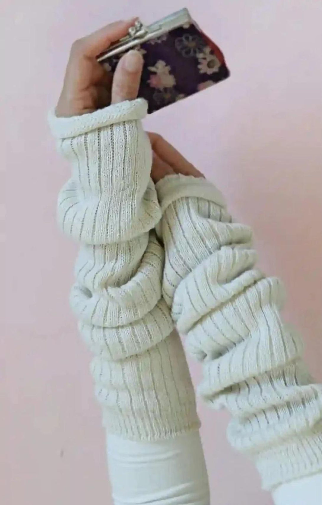 Arm of a woman holding a camera wearing a white cut and sewn shirt in the Ivory color of TABBISOCKS brand Wool Blend Leg and Arm Warmers