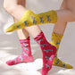 Female leg wearing TABBISOCKS brand Animal Rescue Pairs Schnauzer Socks in CERISE PINK and BITTER YELLOW colors, respectively