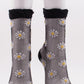 TABBISOCKS brand Daisy Sheer Socks in black with white daisy flower illustrations all over the transparent black fabric.