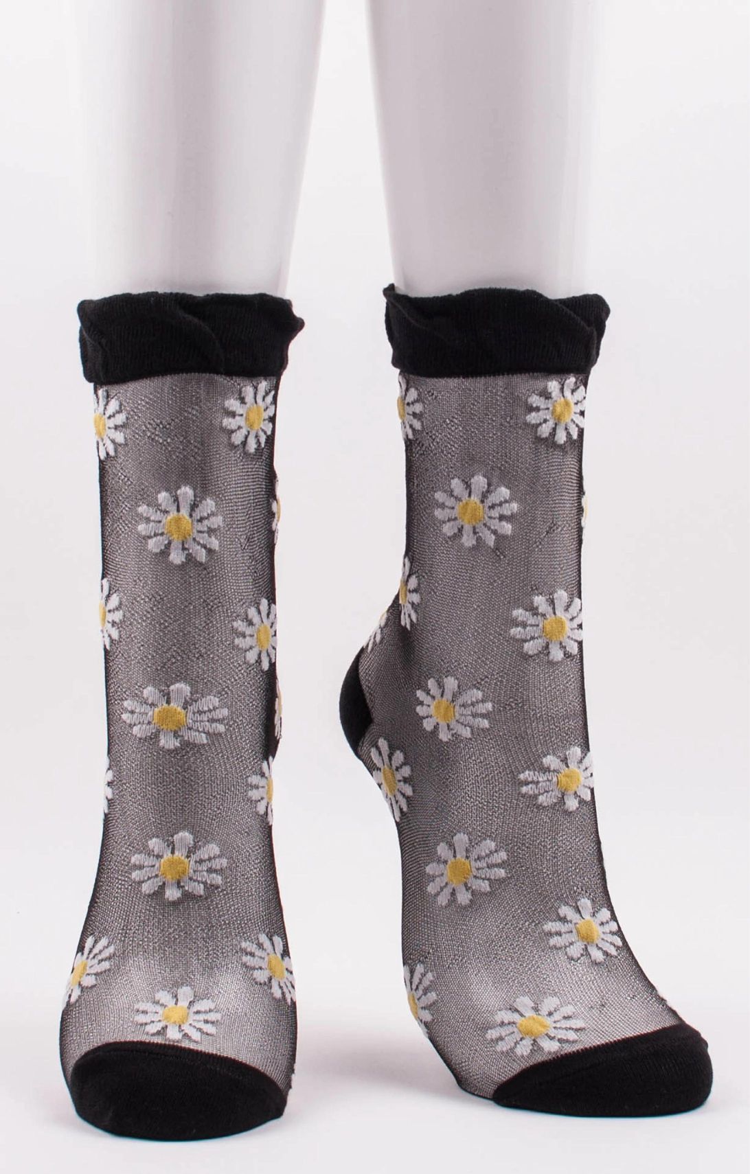 TABBISOCKS brand Daisy Sheer Socks in black with white daisy flower illustrations all over the transparent black fabric.
