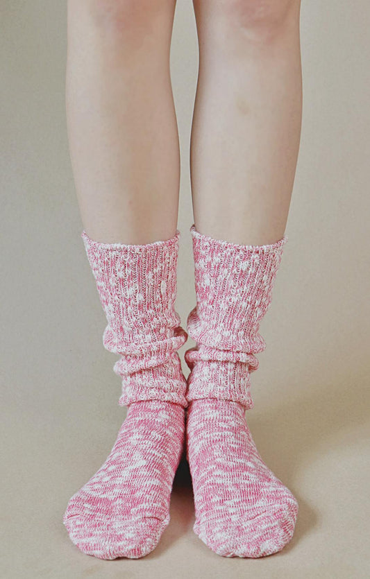 Woman is wearing pink organic cotton crew socks.