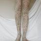 TABBISOCKS brand William Morris collection Corn Cockle tights with an overall floral design and a dull yellow-greenish color