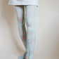Tights called Larkspur from the William Morris collection of the TABBISOCKS brand, with an overall design of illustrated pink flowers in an antique-ish light blue color