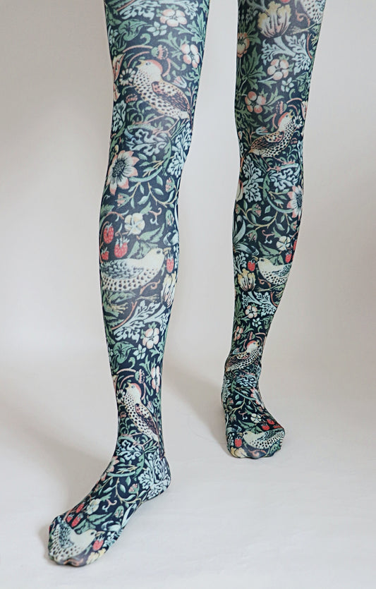 Tights called Strawberry Thief from the William Morris collection of the TABBISOCKS brand, with an overall design of birds and strawberries, in an antique-like navy blue color