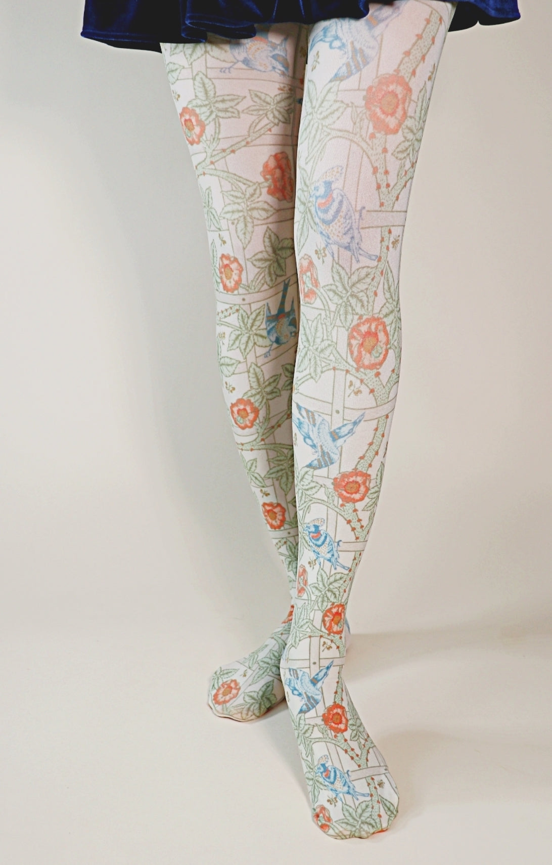 TABBISOCKS brand William Morris collection tights called Trellis or Pomegranate, overall color is dull orange and yellowish green, whitish atmosphere