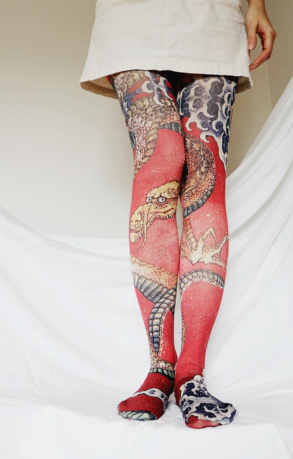 Storong red color. The tights that has a print of Dragon art by Hokusai.